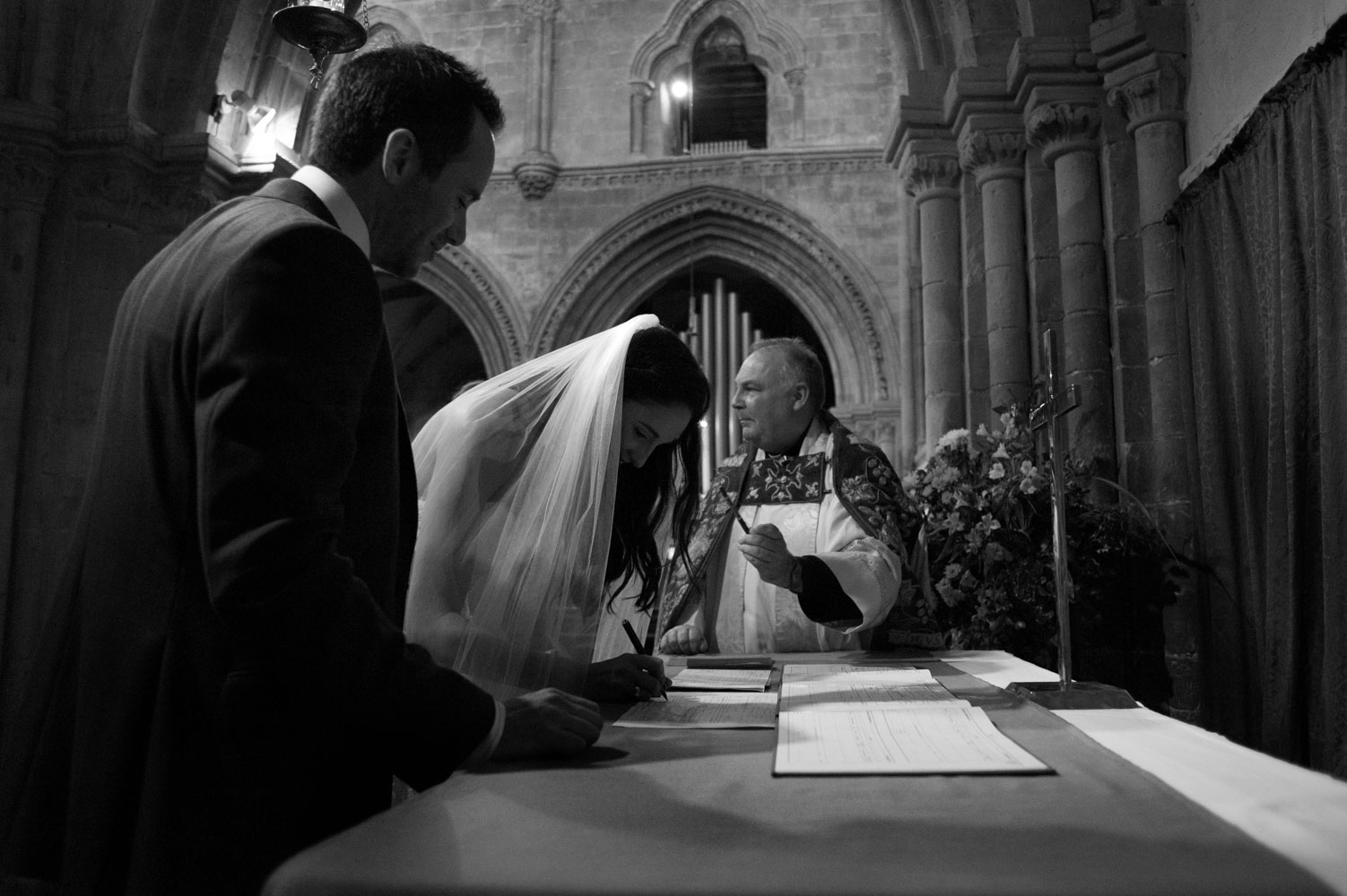 Bride signing register in church 