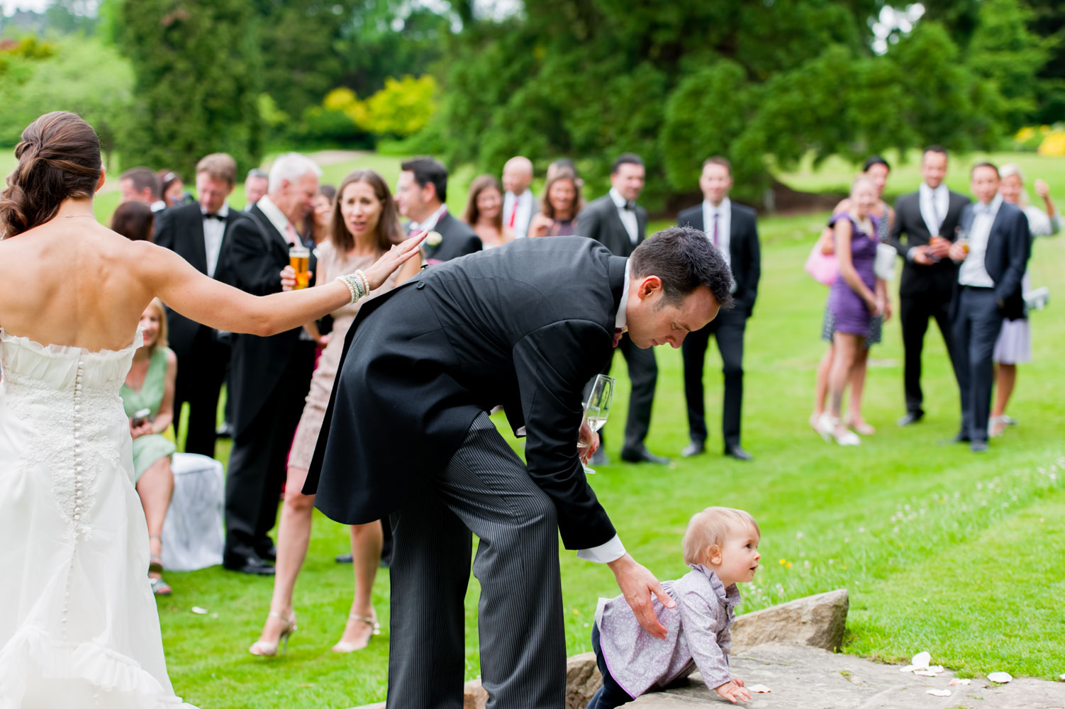 Bride groom and daughter at outdoor wedding reception
