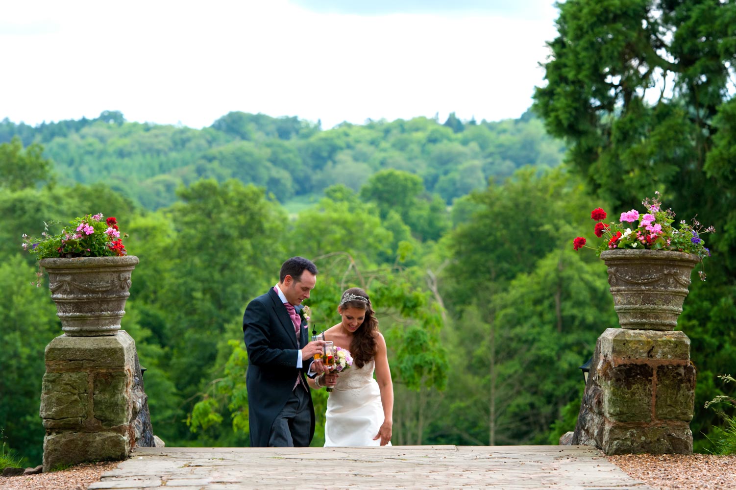 Bride and groom walking up steps at the Ashdown Park Hotel