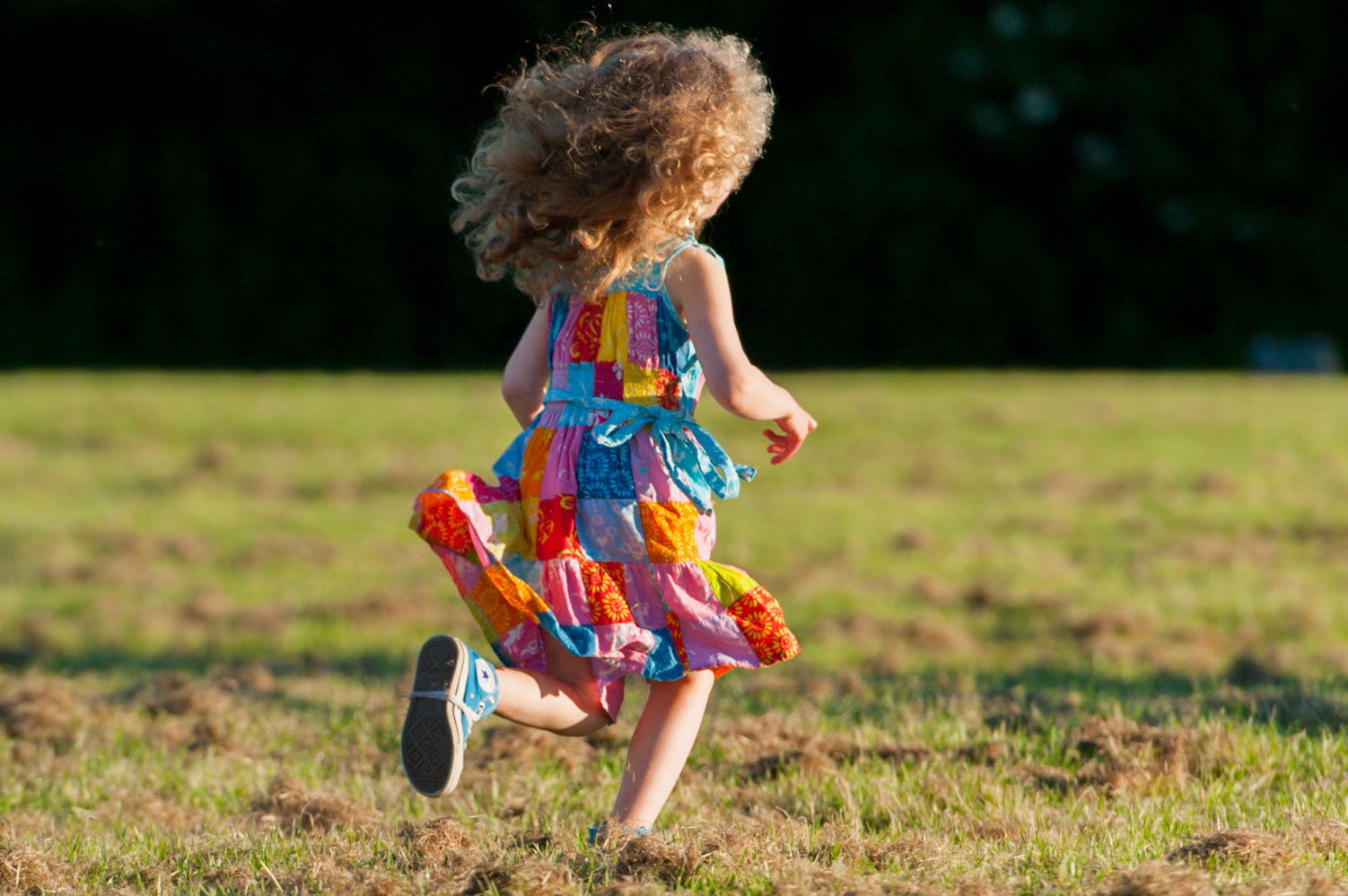 Girl running across a field