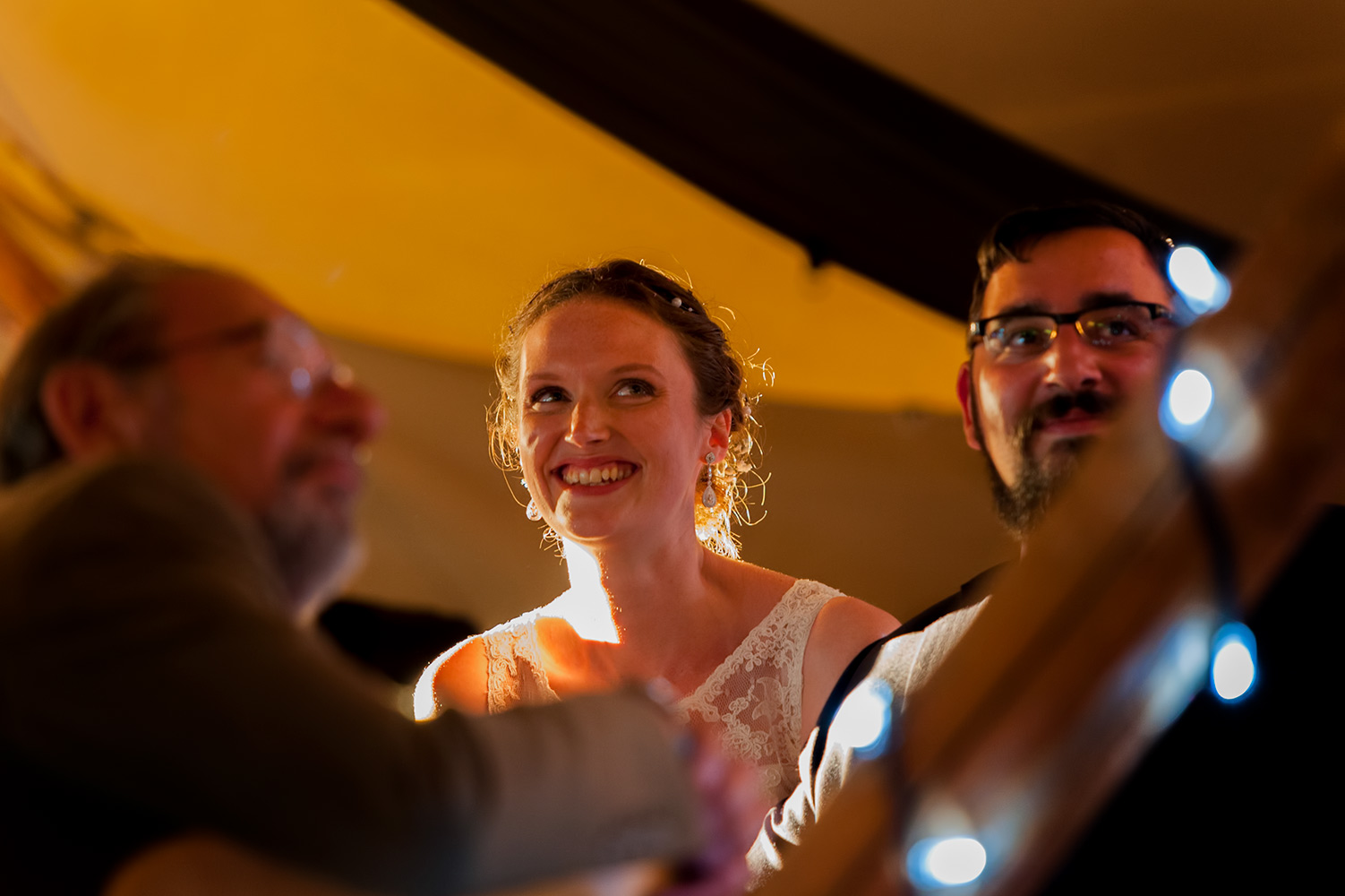 Couple in evening light at marquee wedding reception 