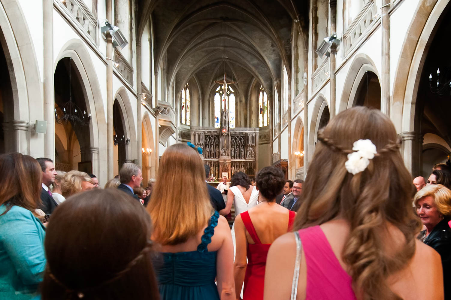 Bridal party walking down the aisle in St Mary Star of the Sea church in Hastings