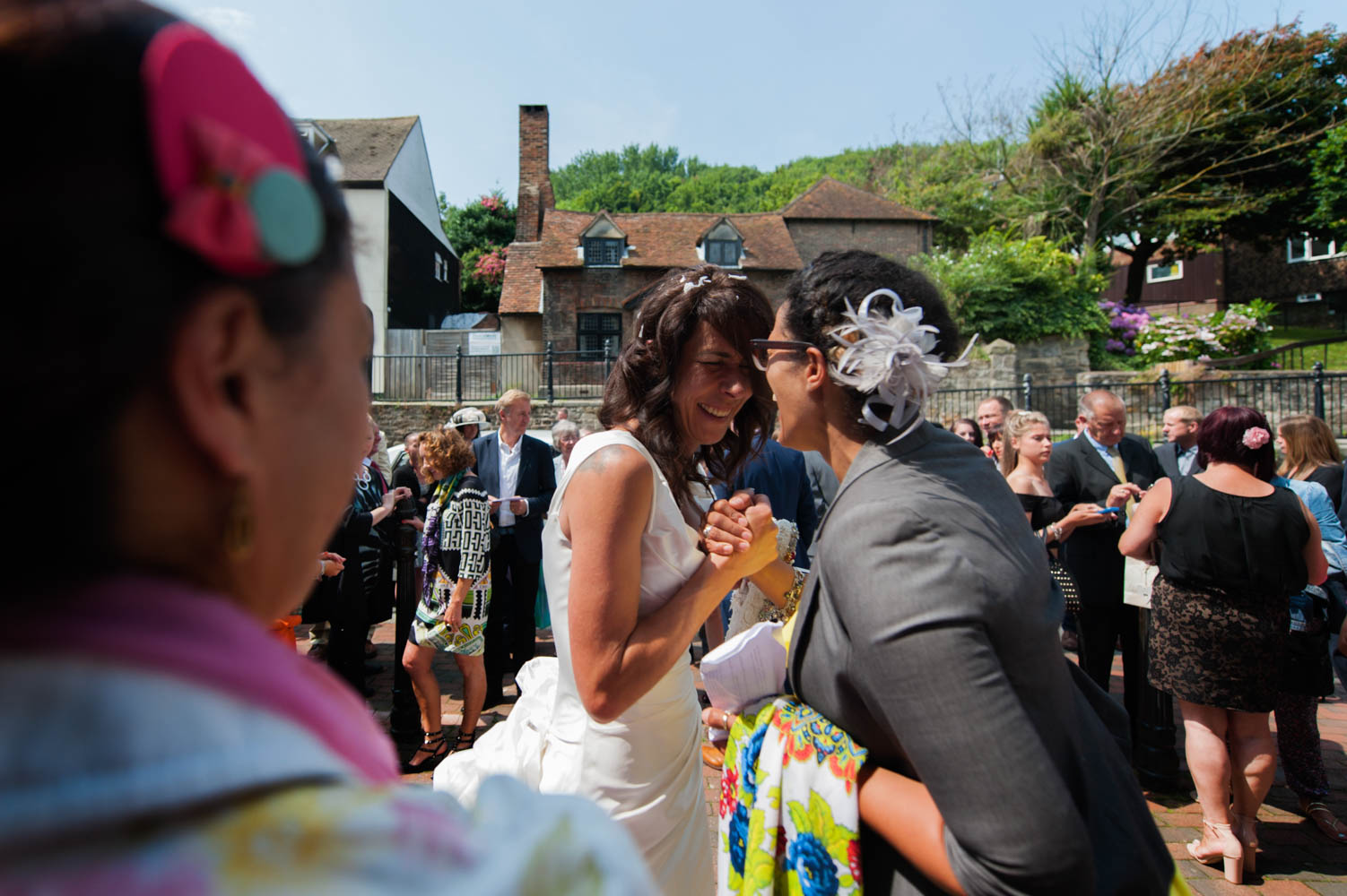 Bride being greeted by guest after church wedding 