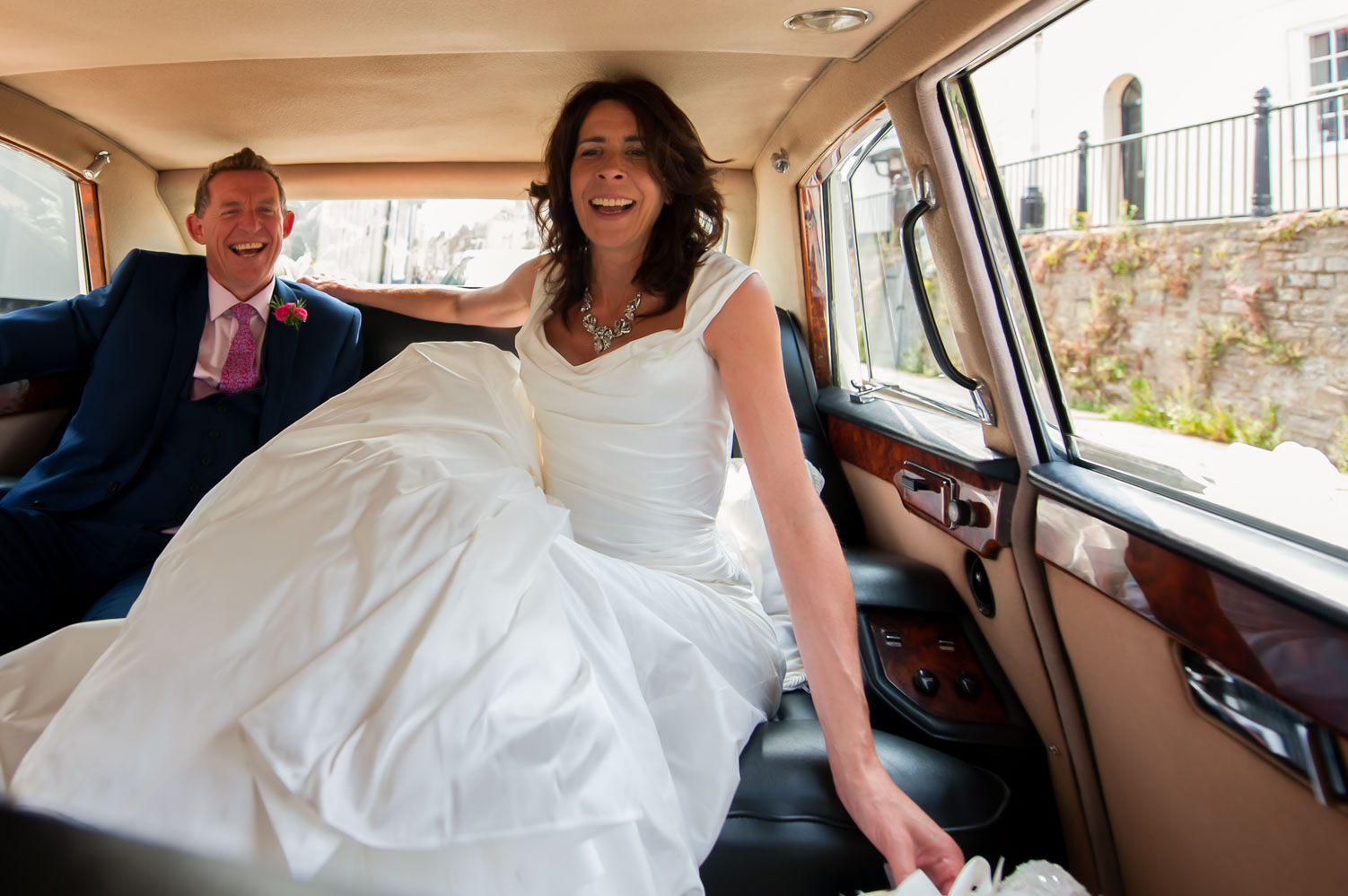 Bride and groom in wedding car