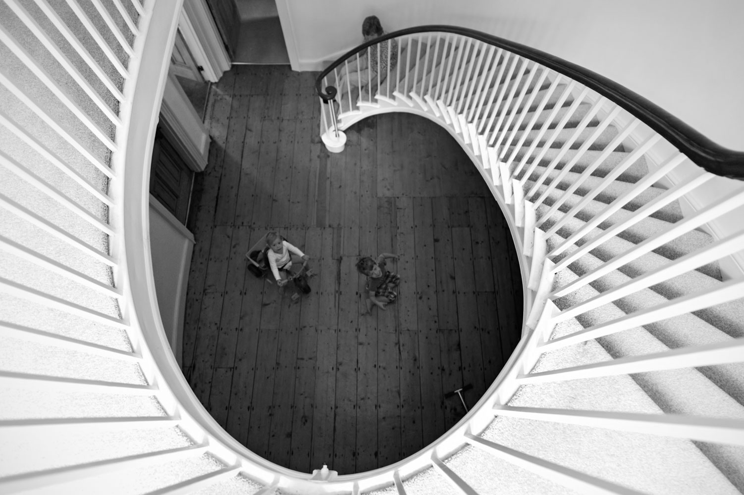 Kids playing and spiral staircase
