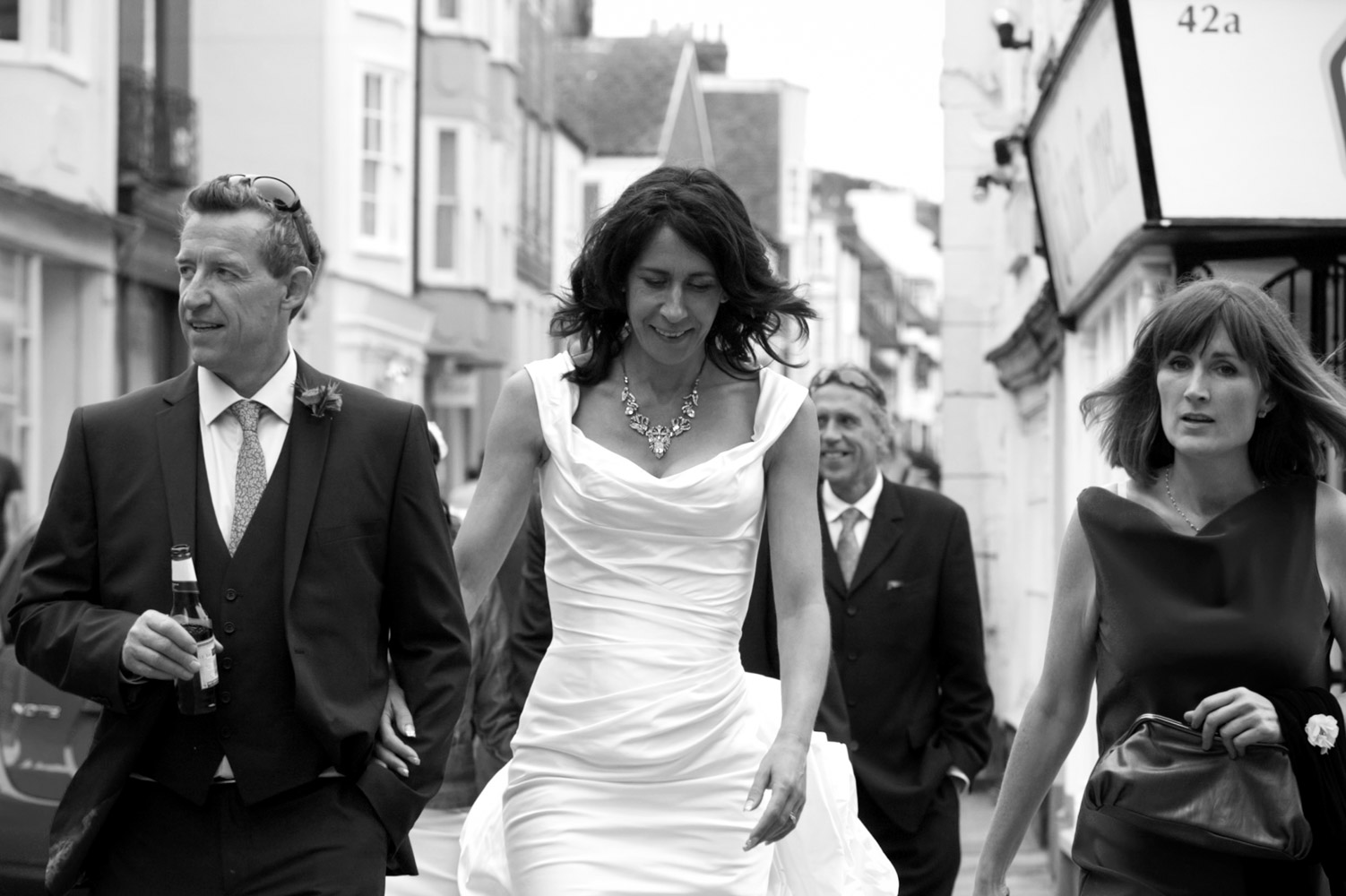 Bridal party walking down the high street in Hastings 