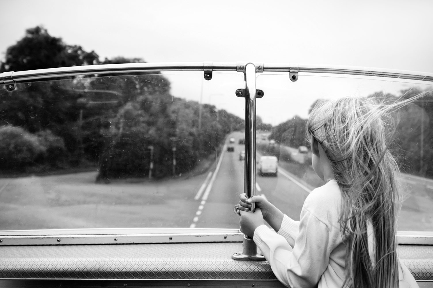 Kids on top deck of open air wedding bus