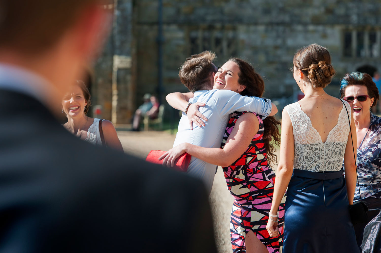 Guests hugging at wedding reception