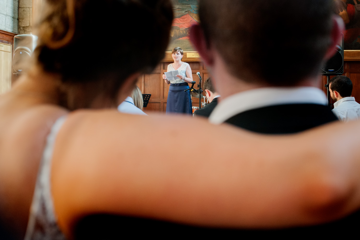 Bride and groom watching wedding speech