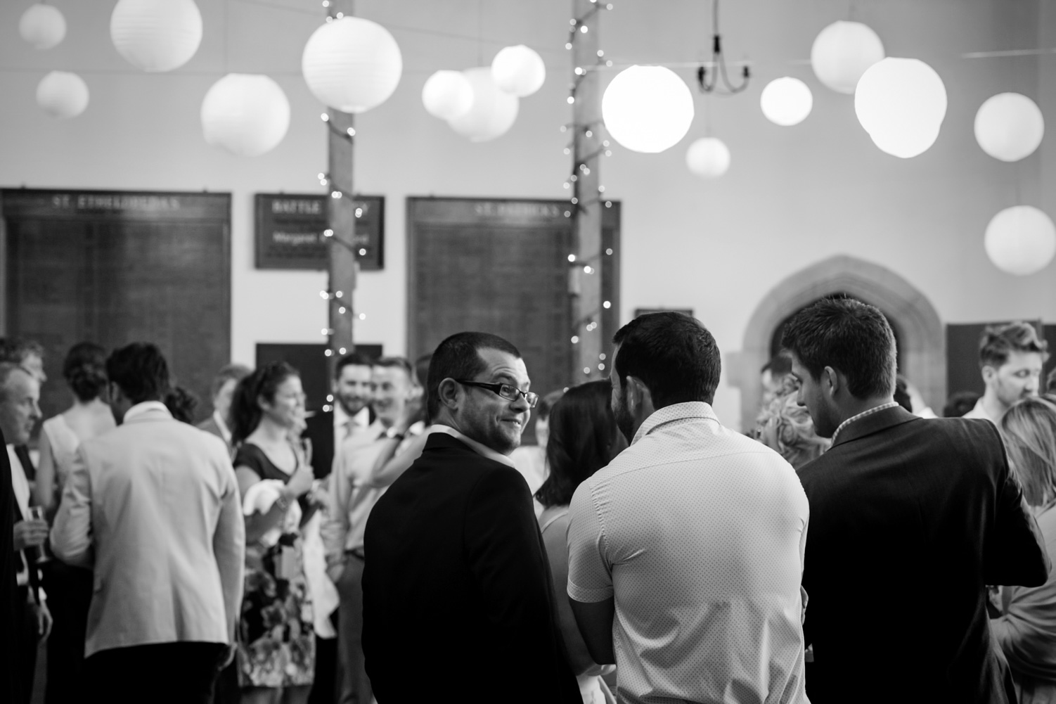 Groom chatting to wedding guest