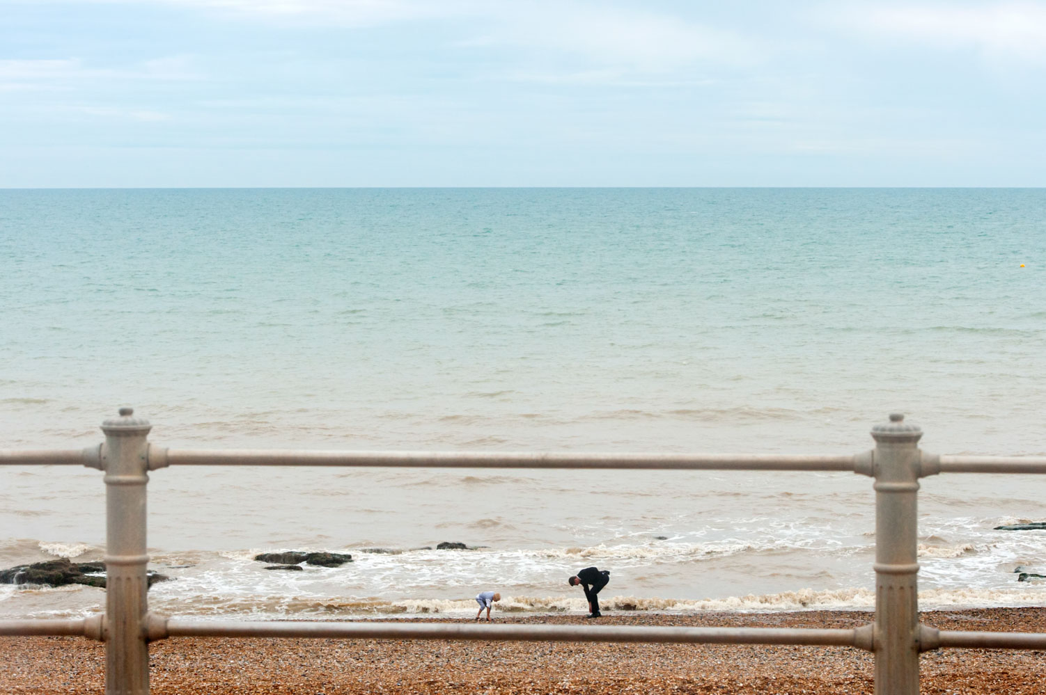 Wedding guests on Hastings beach by informal Sussex wedding photographer James Robertshaw