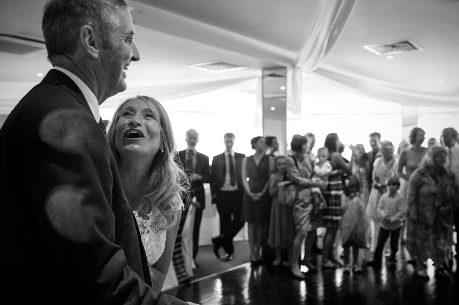 Bride looking at groom before first dance by informal Sussex wedding photographer James Robertshaw