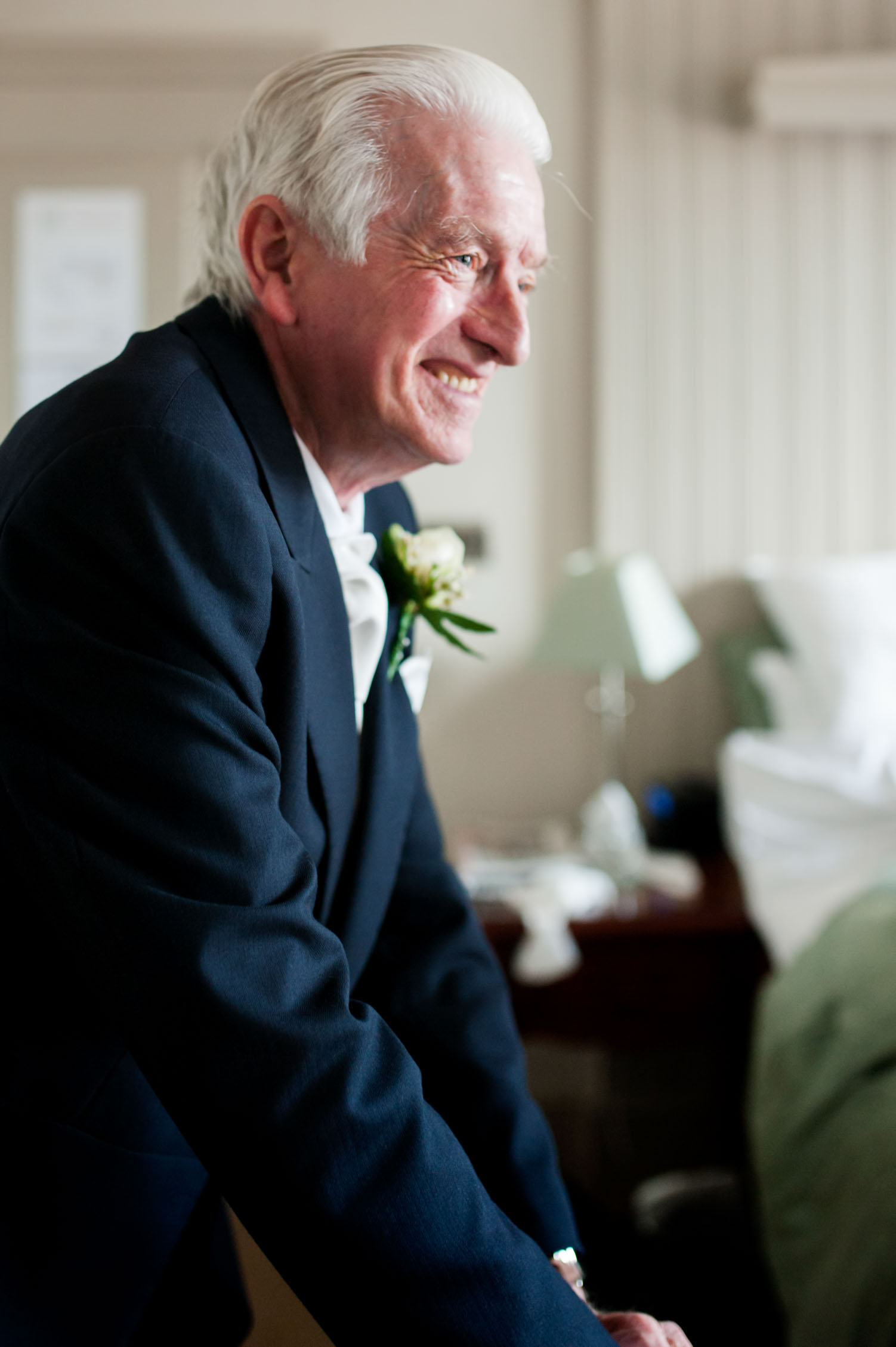 Elderely father of the bride smiling by Sussex documentary photographer James Robertshaw