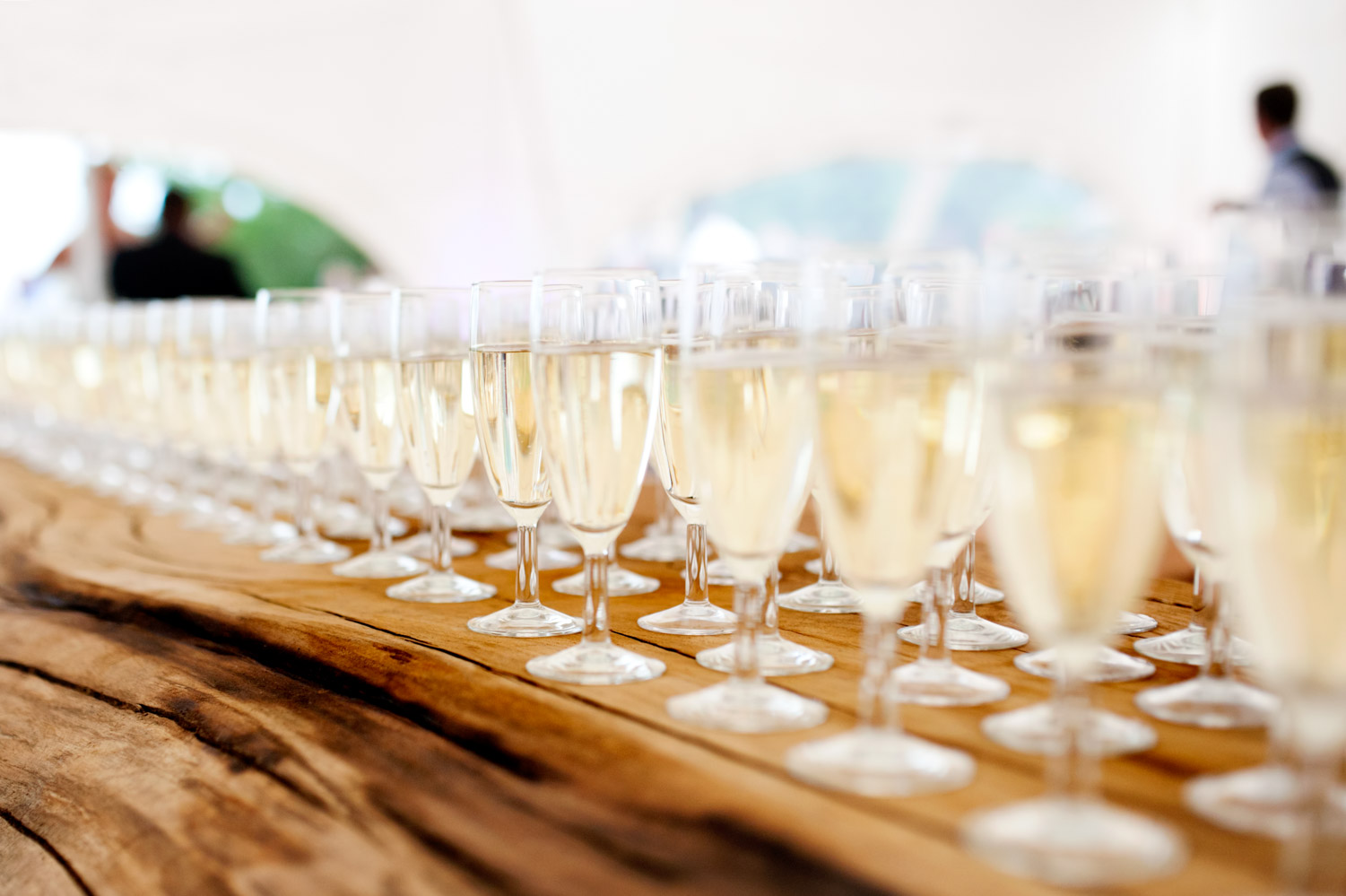 Champagne flutes laid out on wooden table