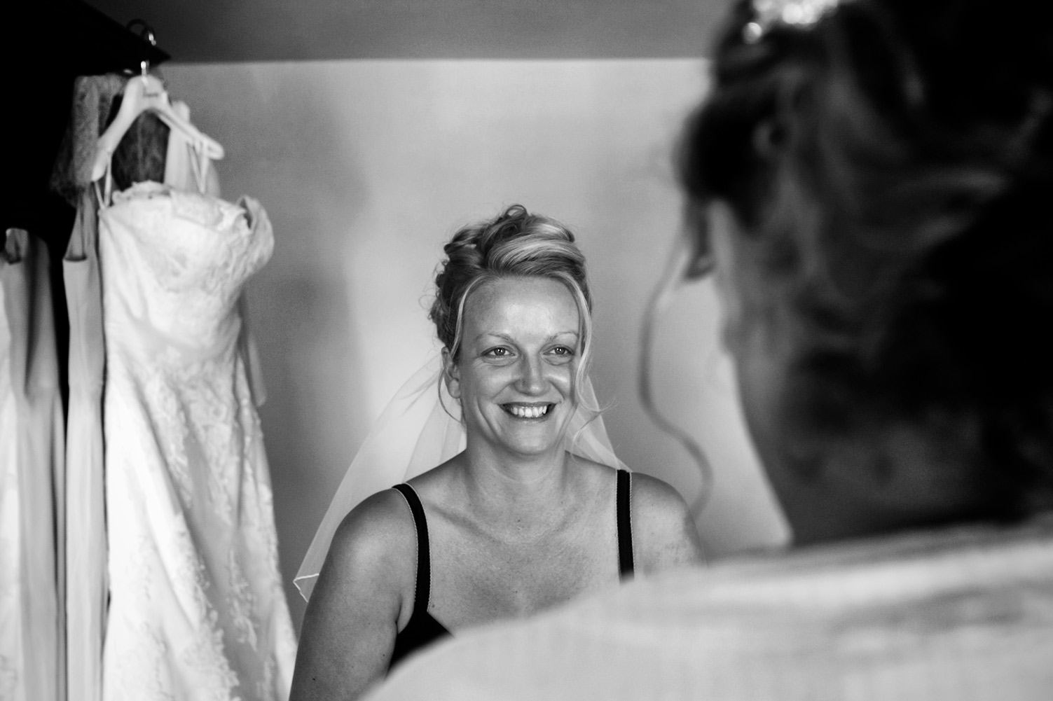 Bride smiling at bridesmaid 