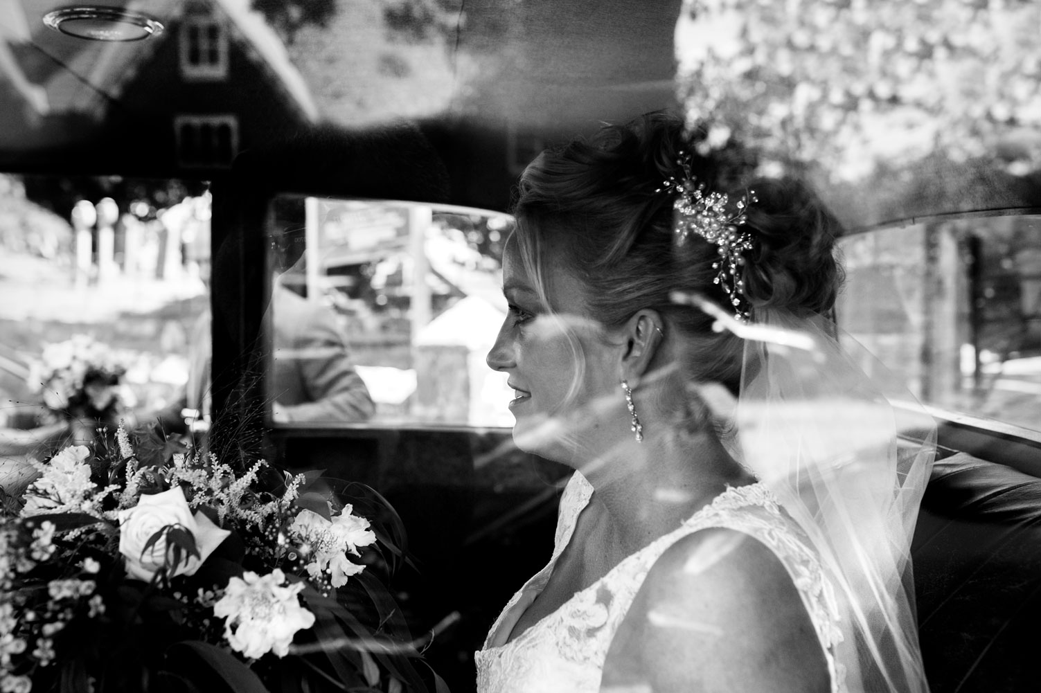 Bride arriving in wedding car by Sussex documentary wedding photographer James Robertshaw