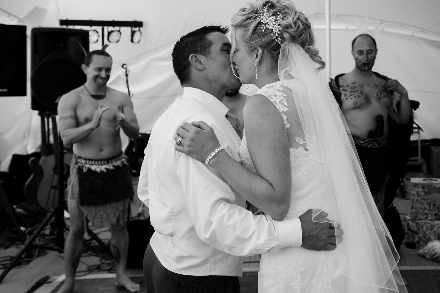 Bride and groom kissing on dance floor