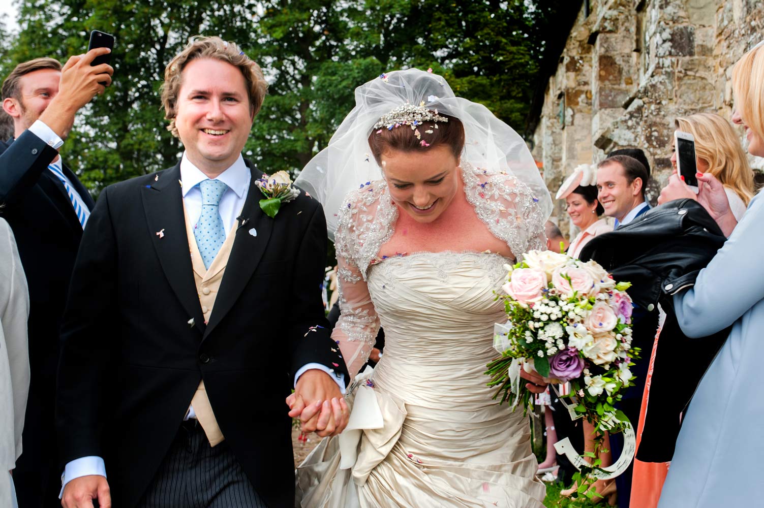 Confetti and couple outside church