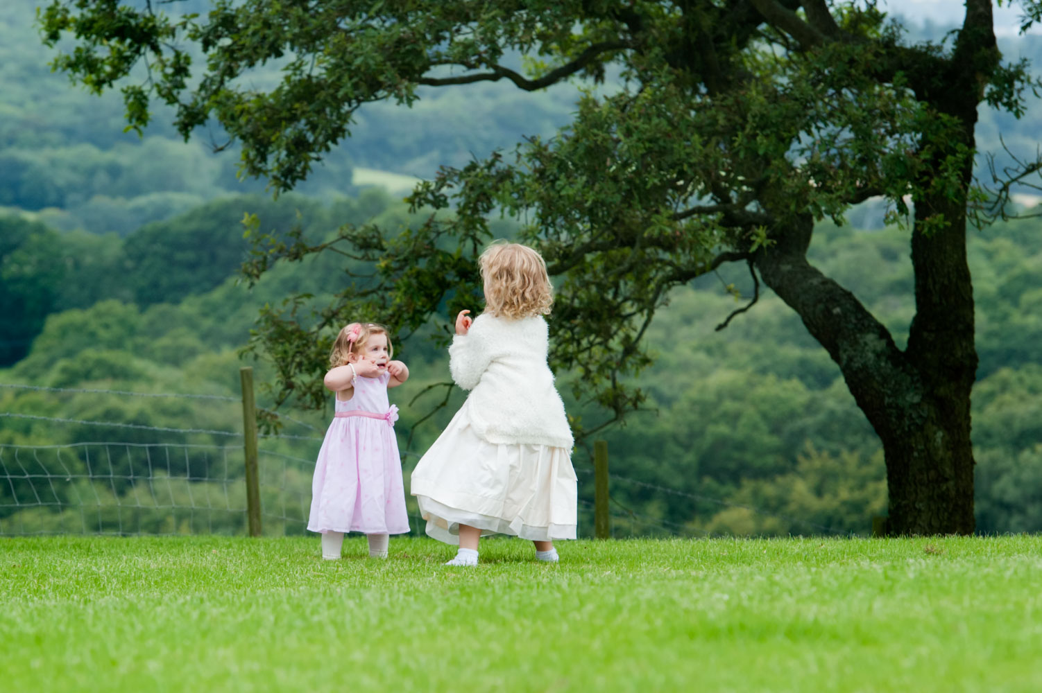 Kids playing outdoors at rural wedding reception