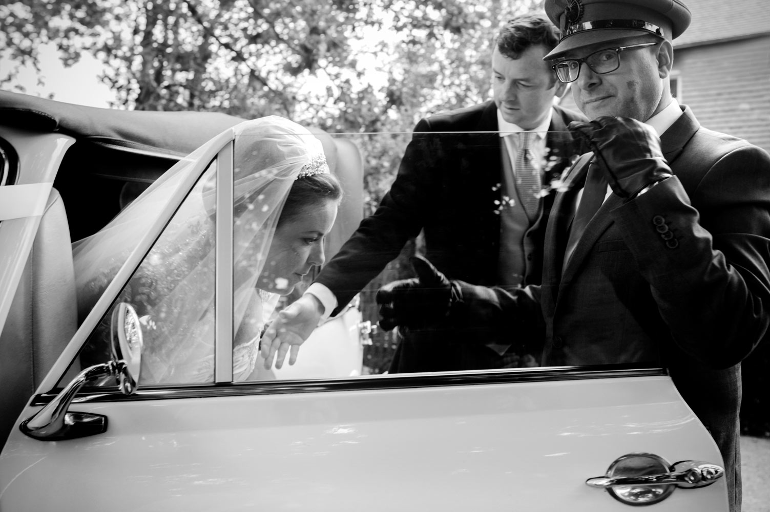 Bride alighting from wedding car by east Sussex wedding photographer James Robertshaw