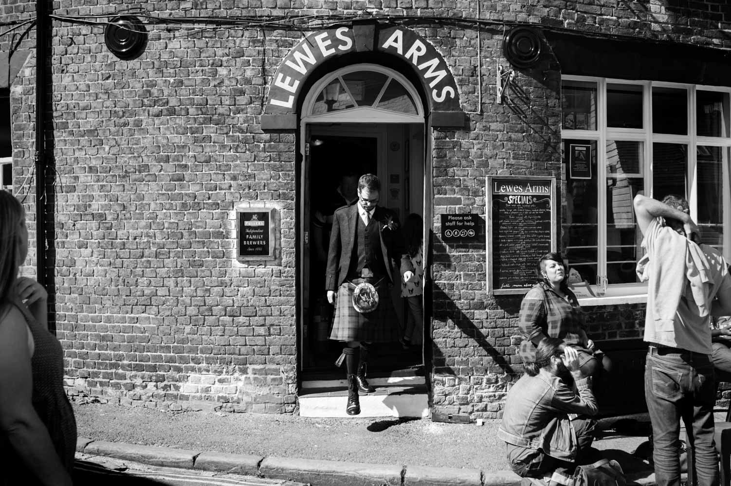 Groom stepping out of the Lewes Arms pub