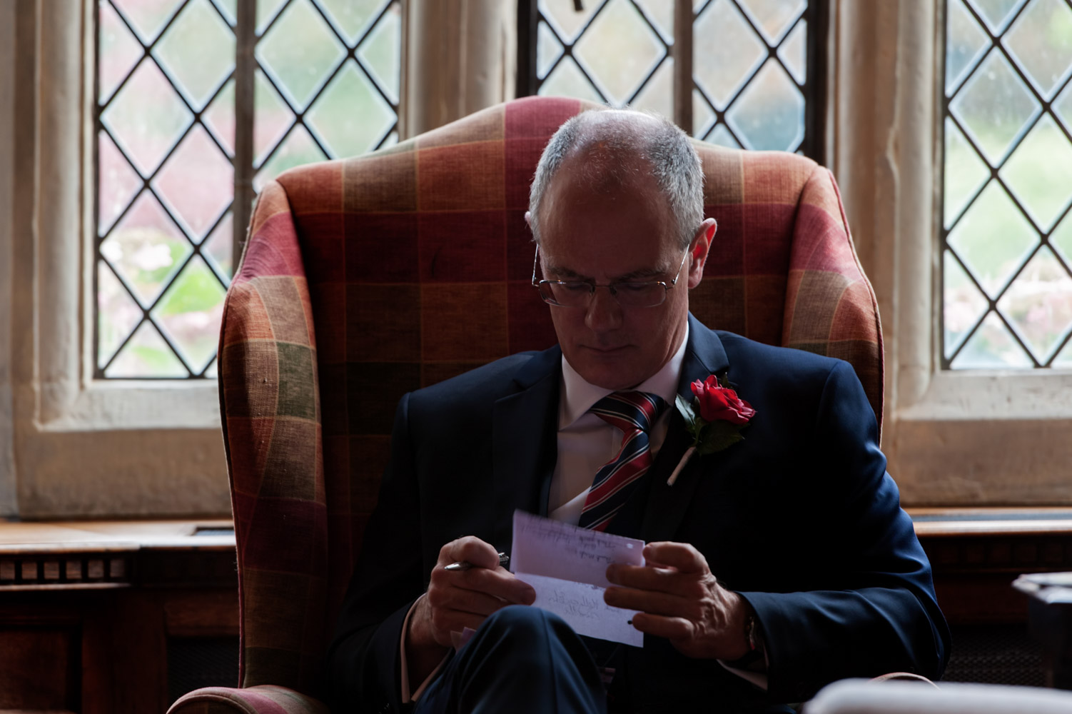 Groom working on speech at Smallfield Place wedding