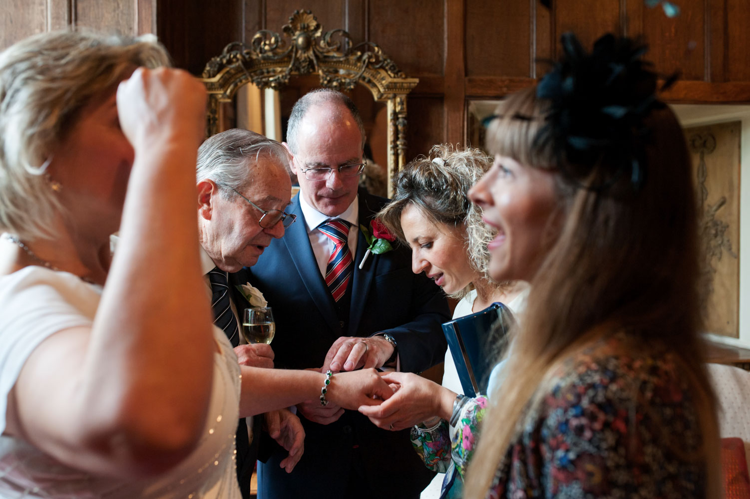 Guests looking at couples wedding rings