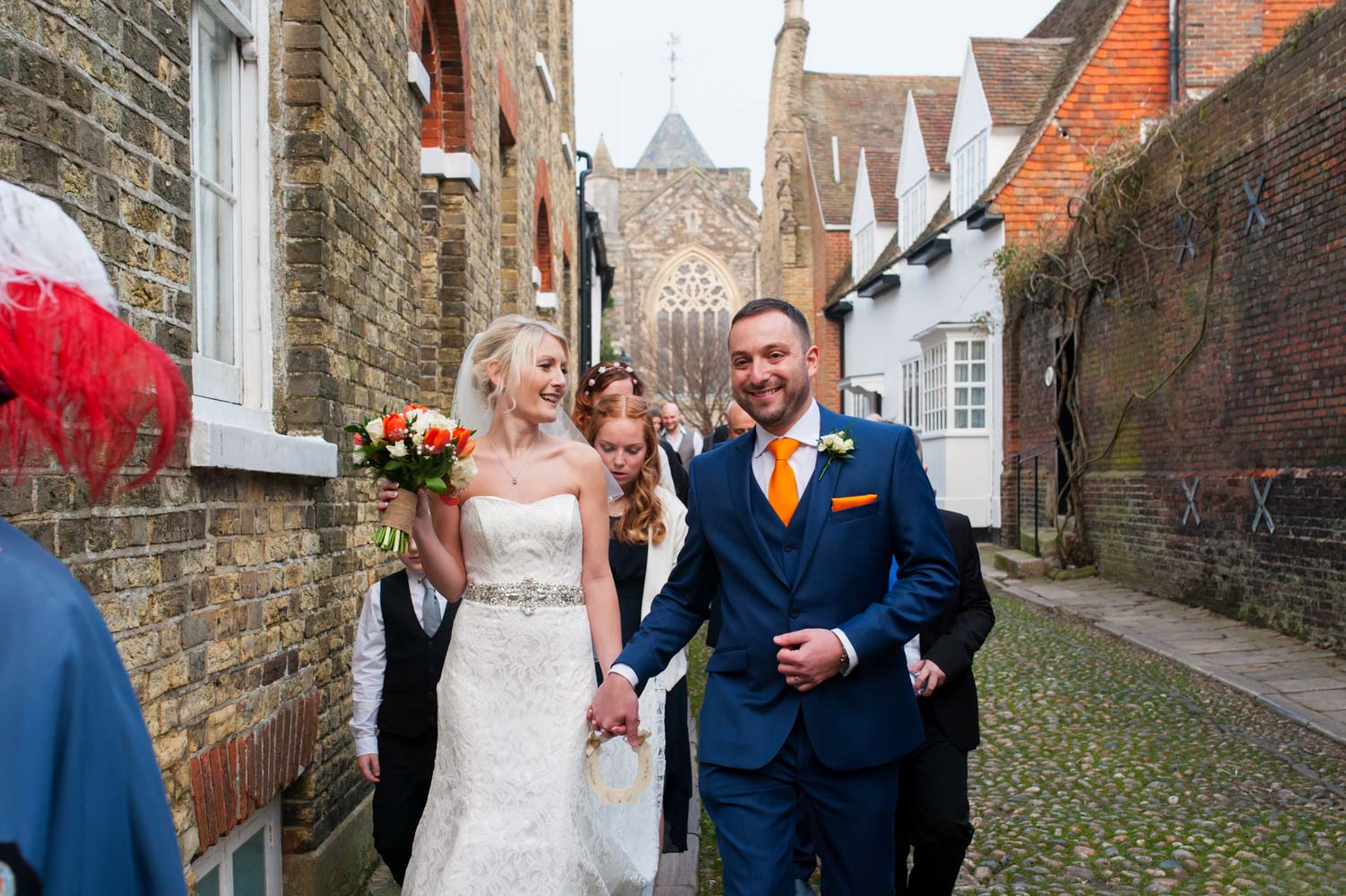 Bride groom and bridal party walking through Rye