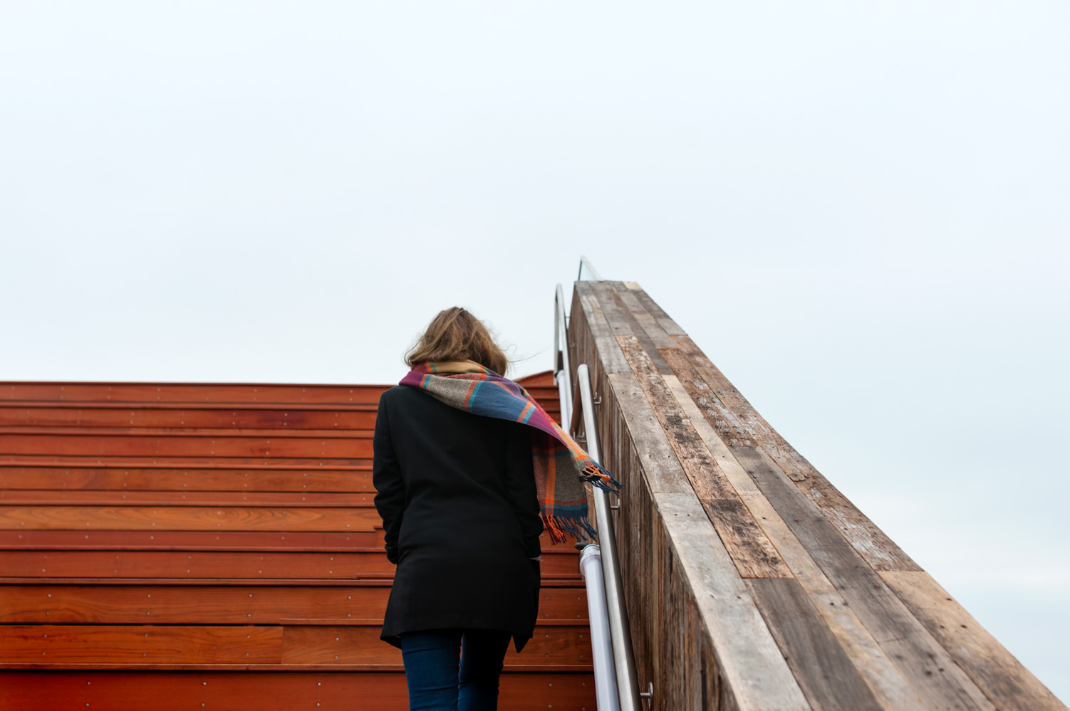 Young woman walking up steps