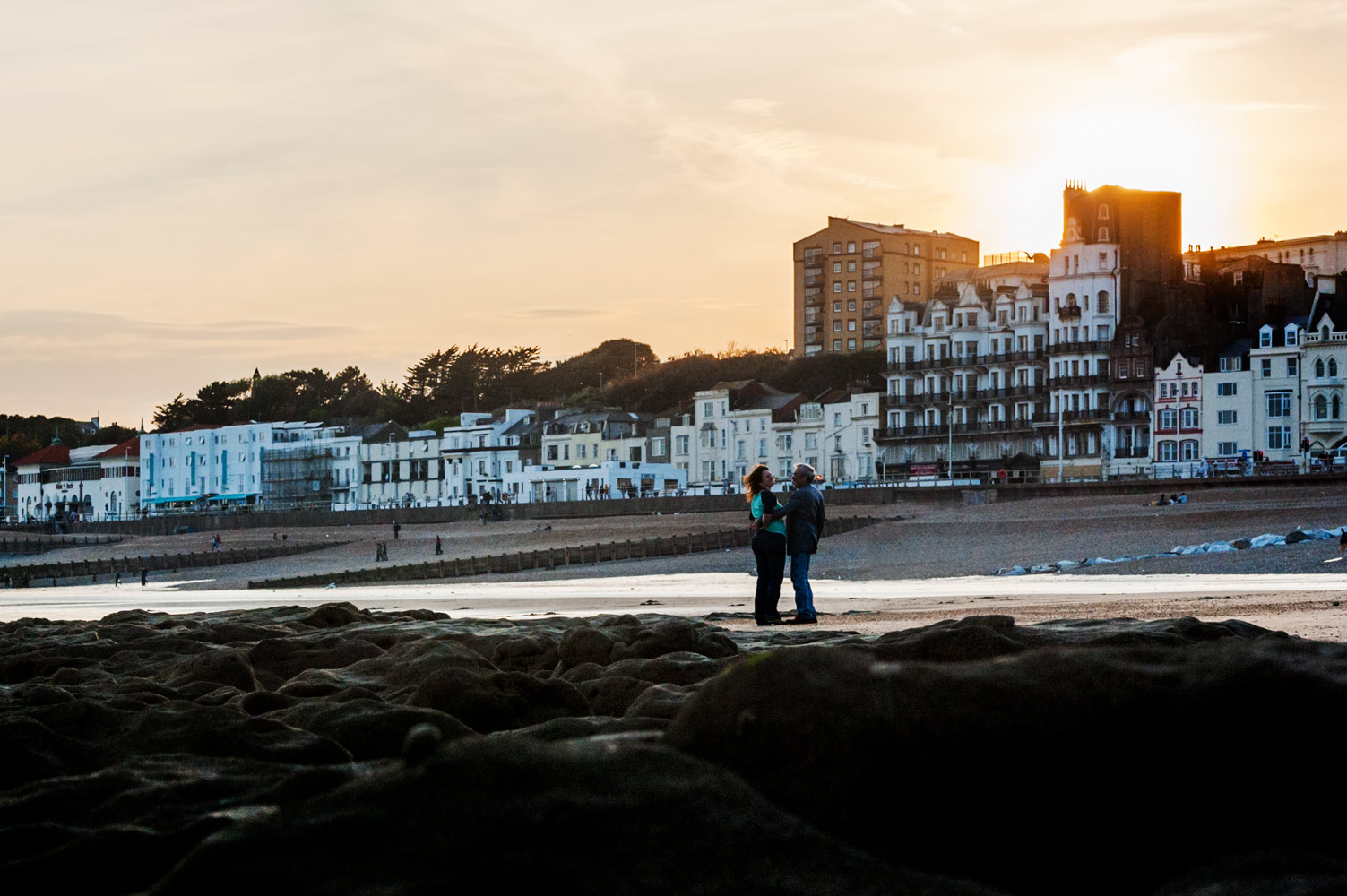 Couple embracing on Hastings beach