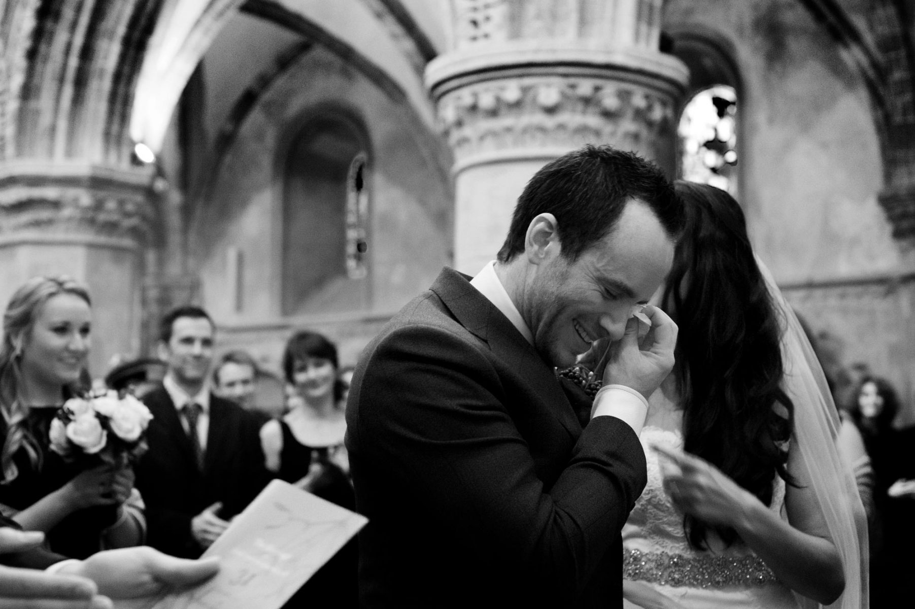 Groom wiping tear by Sussex wedding photographer James Robertshaw