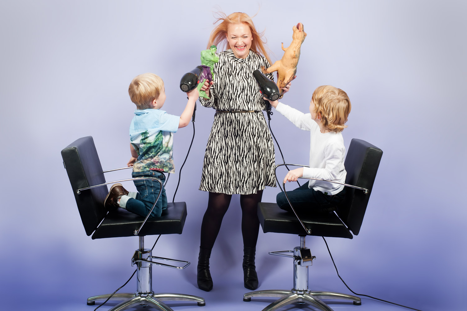 Portrait of hair stylist with her two children