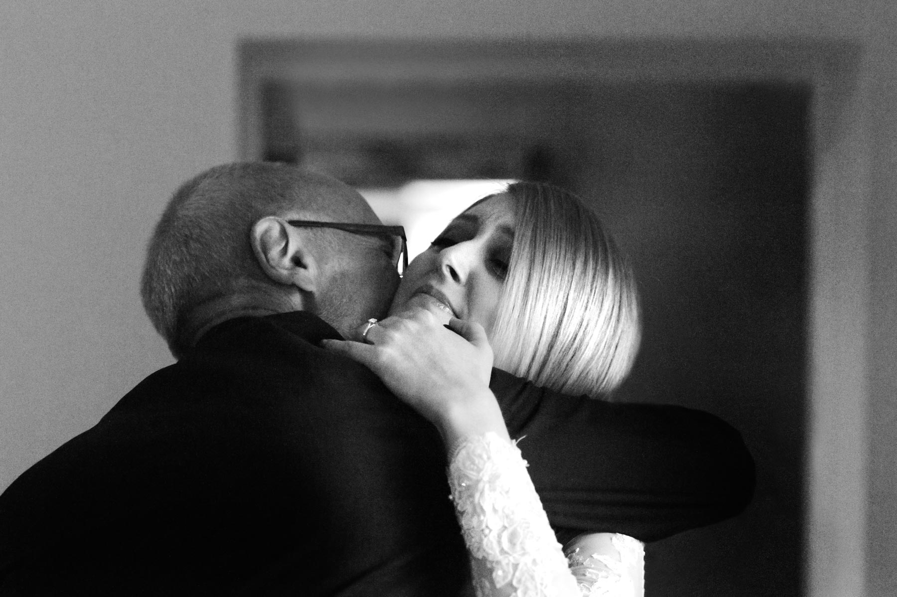 Bride and father embracing by Sussex wedding photographer James Robertshaw