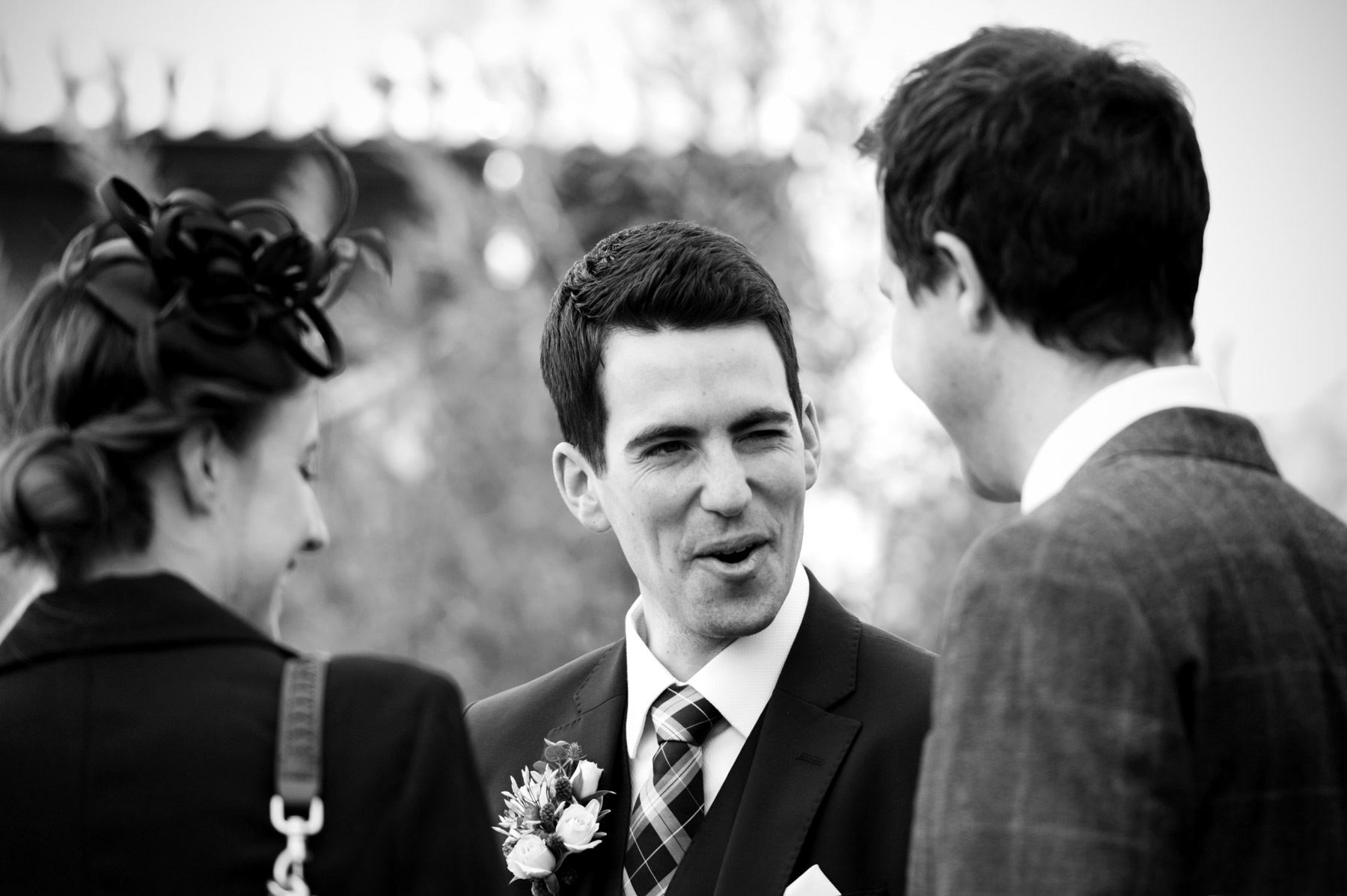 Groom greeting wedding guests