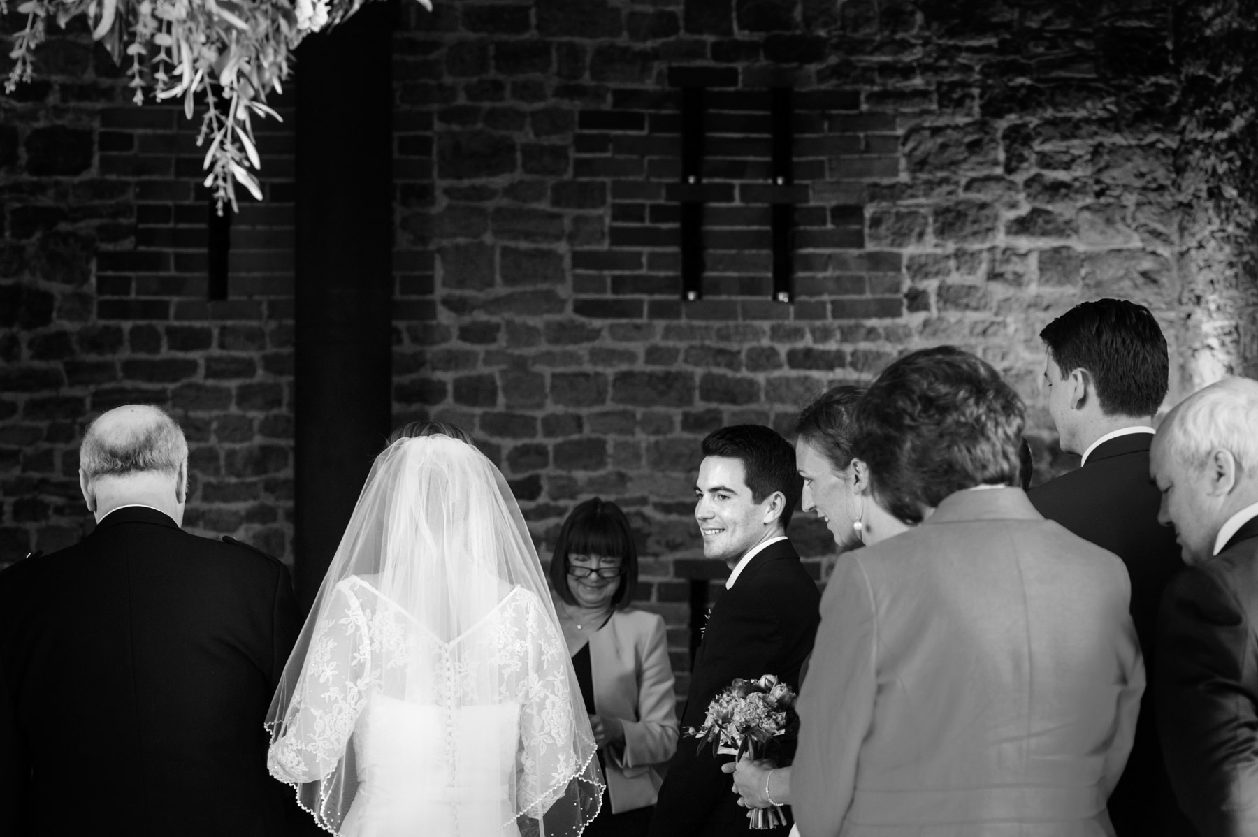 Groom looking over shoulder at bride