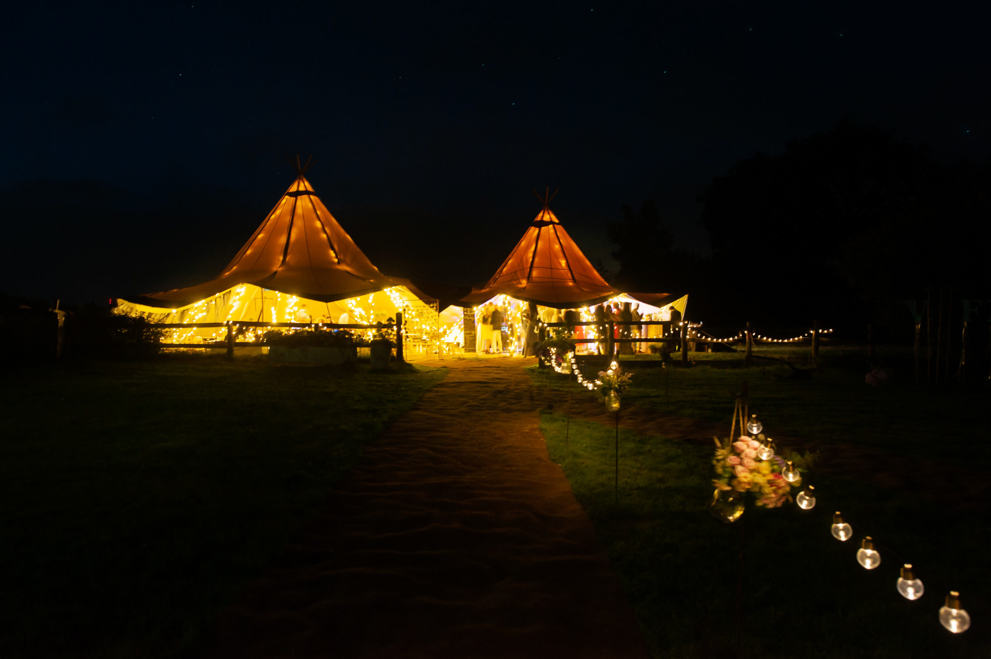 Wedding lit up marquee at night.