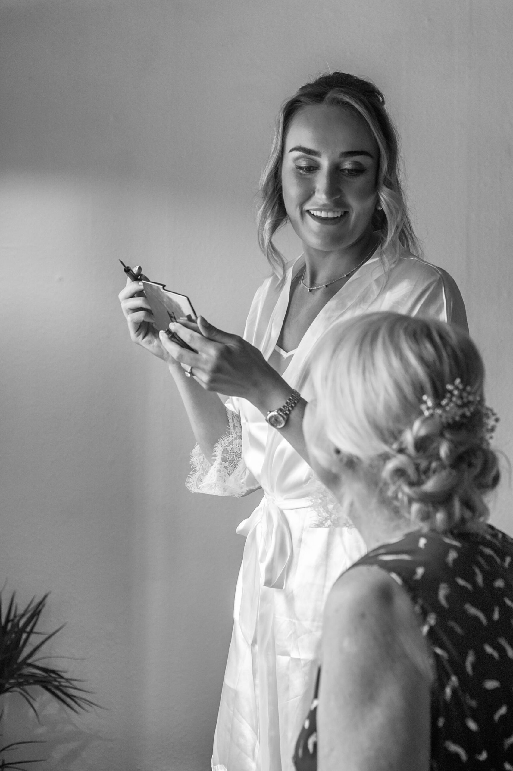 Bride applying make up by East Sussex documentary wedding photographer James Robertshaw