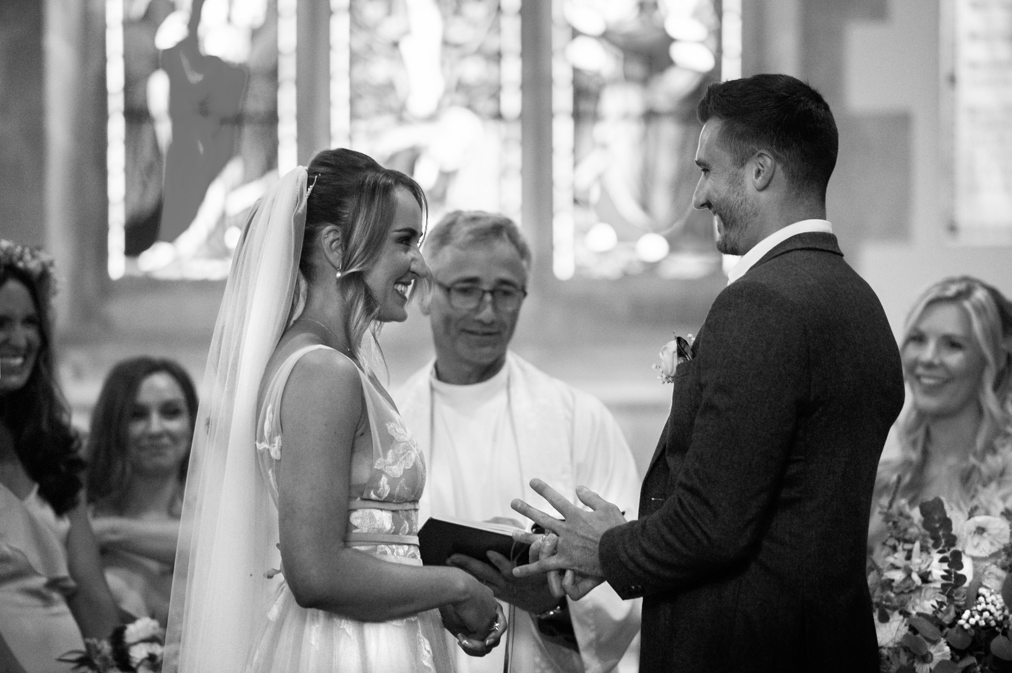 Bride and groom smiling at each other during ceremony.