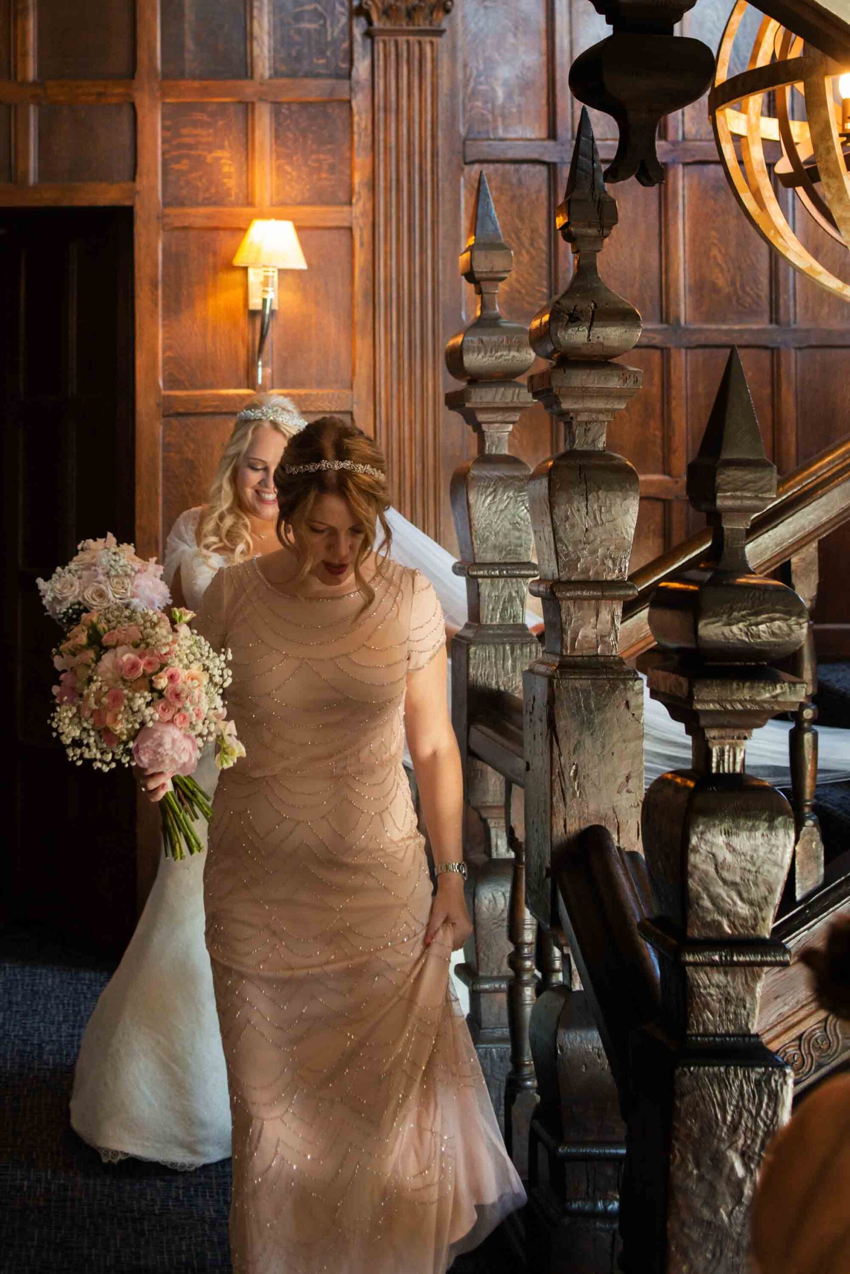 Bride and bridemaid on staircase at great Fosters