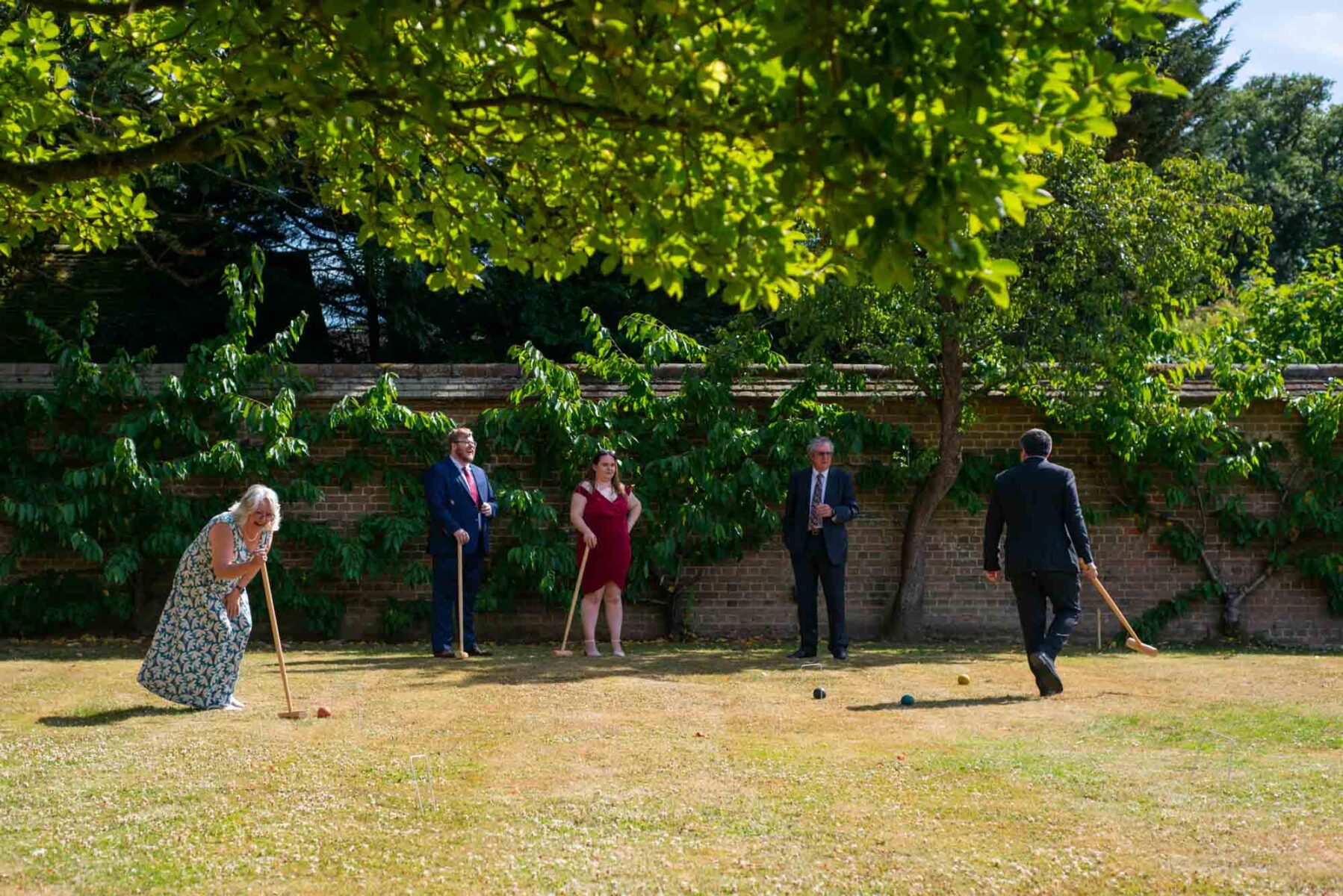 Wedding guests playing croquet at Great Fosters Wedding