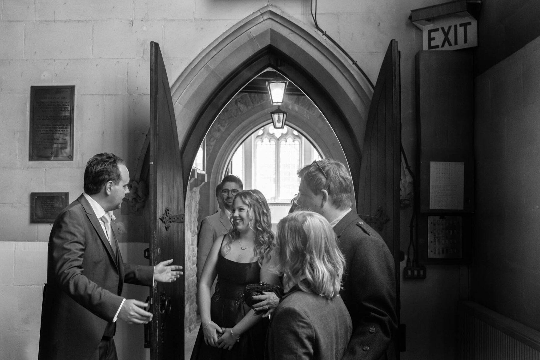 Groom welcoming guests at St Mary's Weybridge
