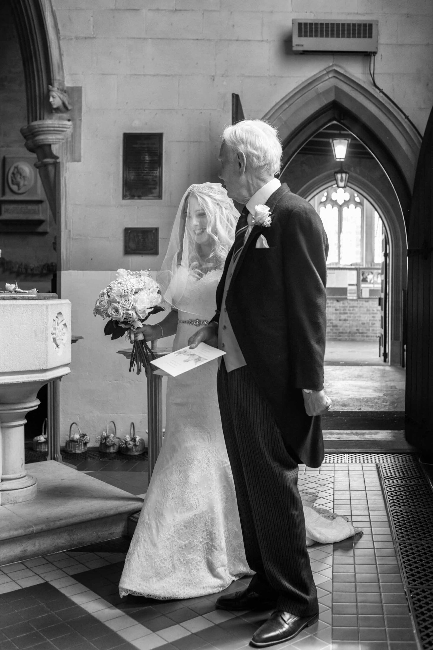 Bridal and father walking into St Mary's Church Weybridge