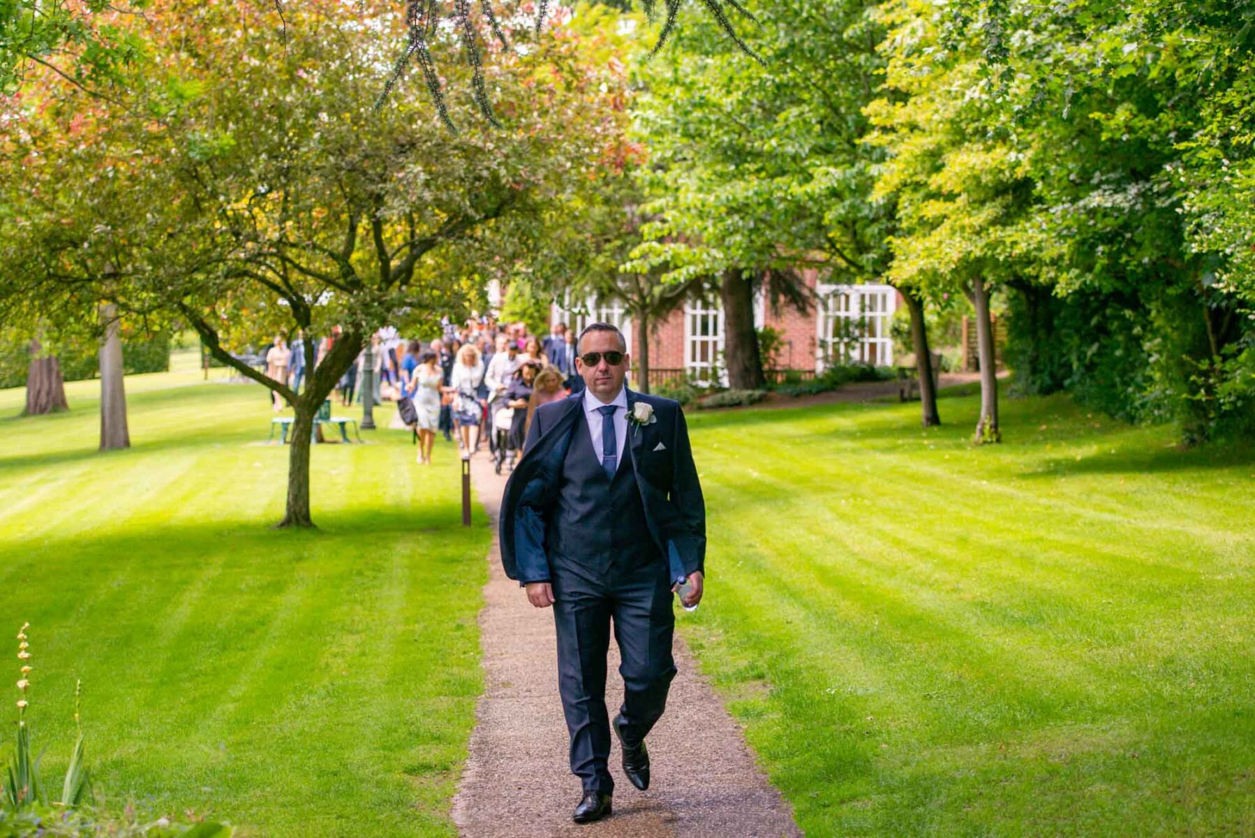 Groom walking towards the camera at the Orangery, Maidstone