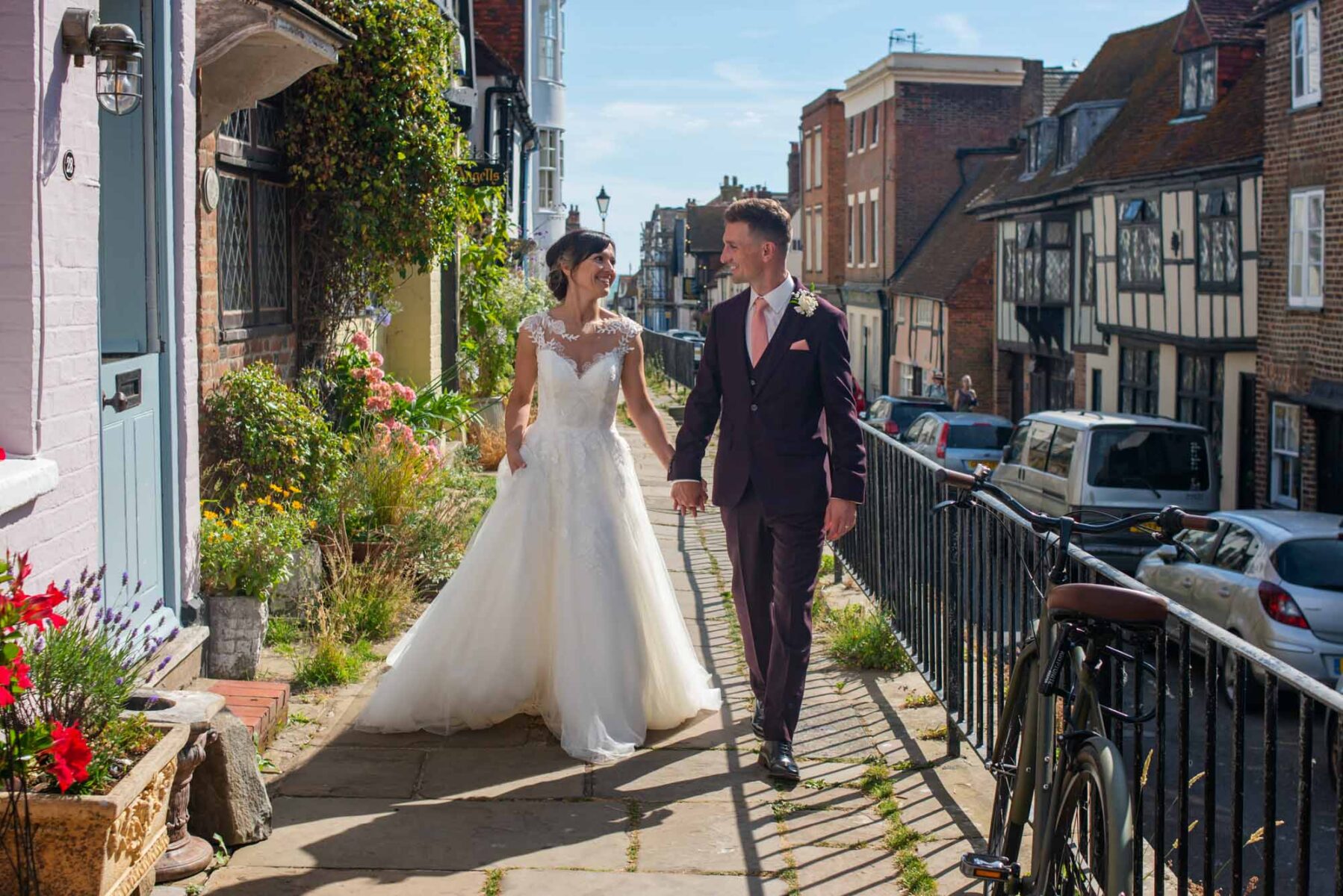 Newlyweds walking down All Saints Street in Hastings Old Town
